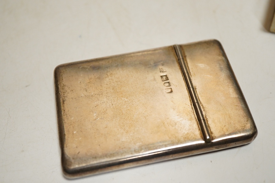 An Edwardian silver card case, London, 1903, Sampson Mordan & Co, plain rectangular form with sprung hinged cover, length 8.7cm., interior gilt together with a matchbox cover with linear engine turned decoration Birmingh